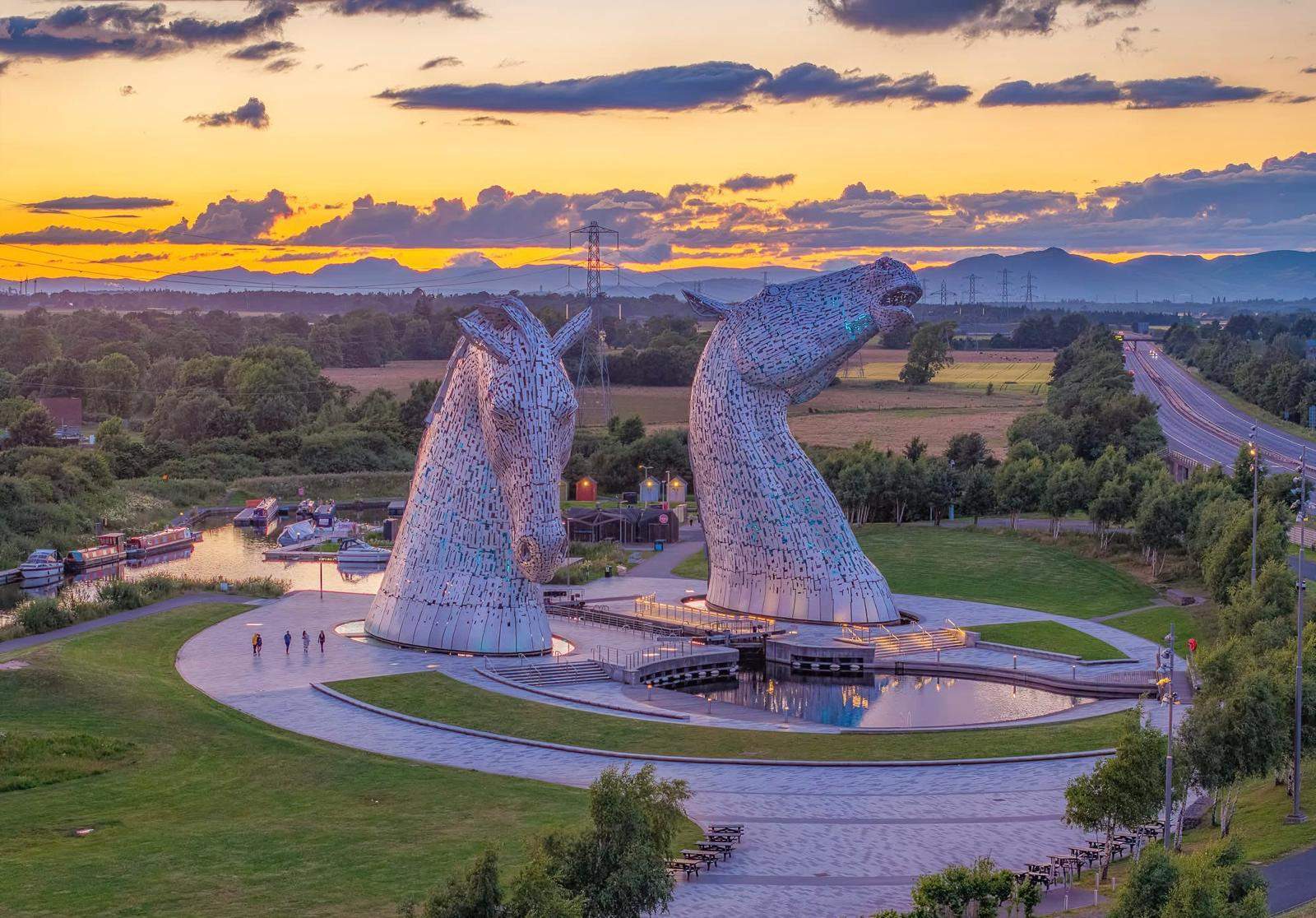 Aerial view of The Kelpies at sunset with Helix Park and canal