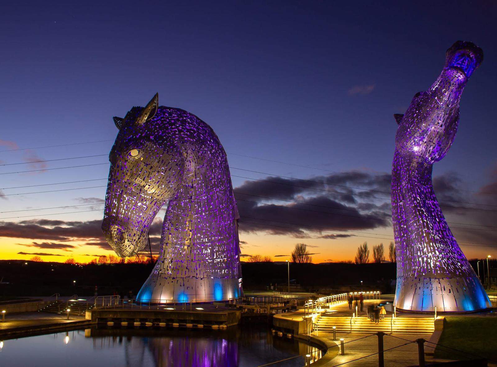 The Kelpies sculptures at sunset with purple lighting