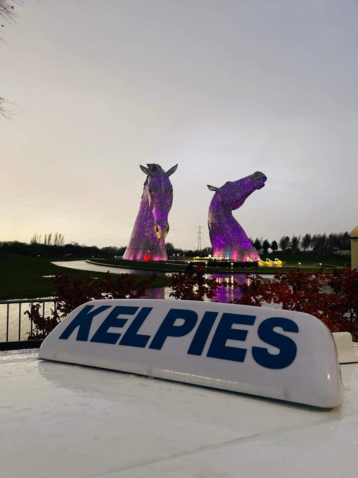 Kelpies Cabs private hire vehicle in front of The Kelpies sculptures